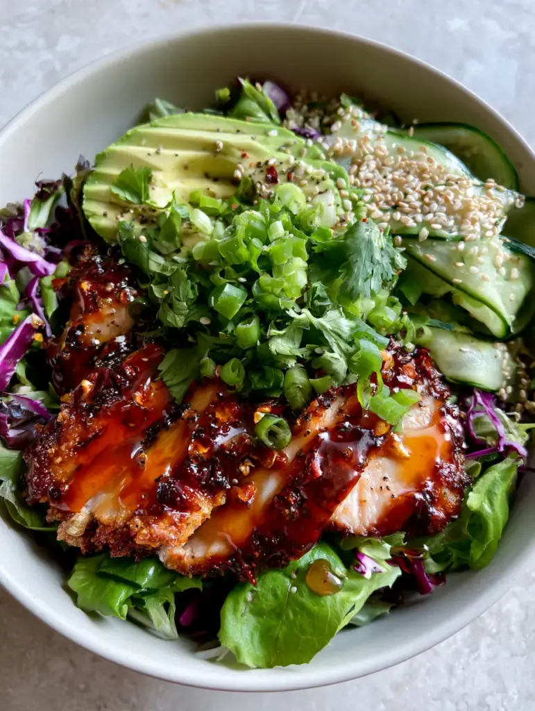 Hot Honey Chicken Salad: The Ultimate Crispy & Spicy Salad Experience 1 Gourmet Hot Honey Chicken Salad with cucumber ribbons, purple cabbage, and a heavy garnish of scallions.