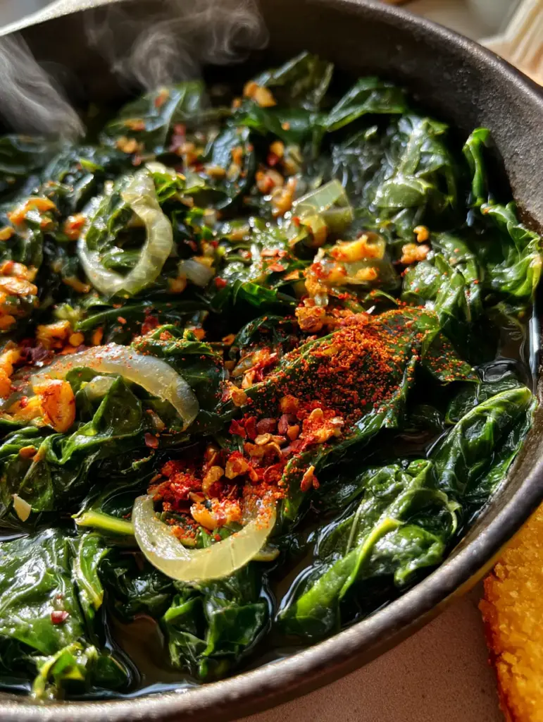 Vegan Collard Greens: The Ultimate Silky, Smoky Soul Food Recipe 1 Close-up of translucent onions and golden-brown garlic in a pot of Vegan Collard Greens.