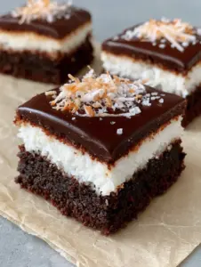 Macro photography of Mounds Brownies showing the dense dark chocolate crumb and moist coconut filling. (Mounds Brownies)